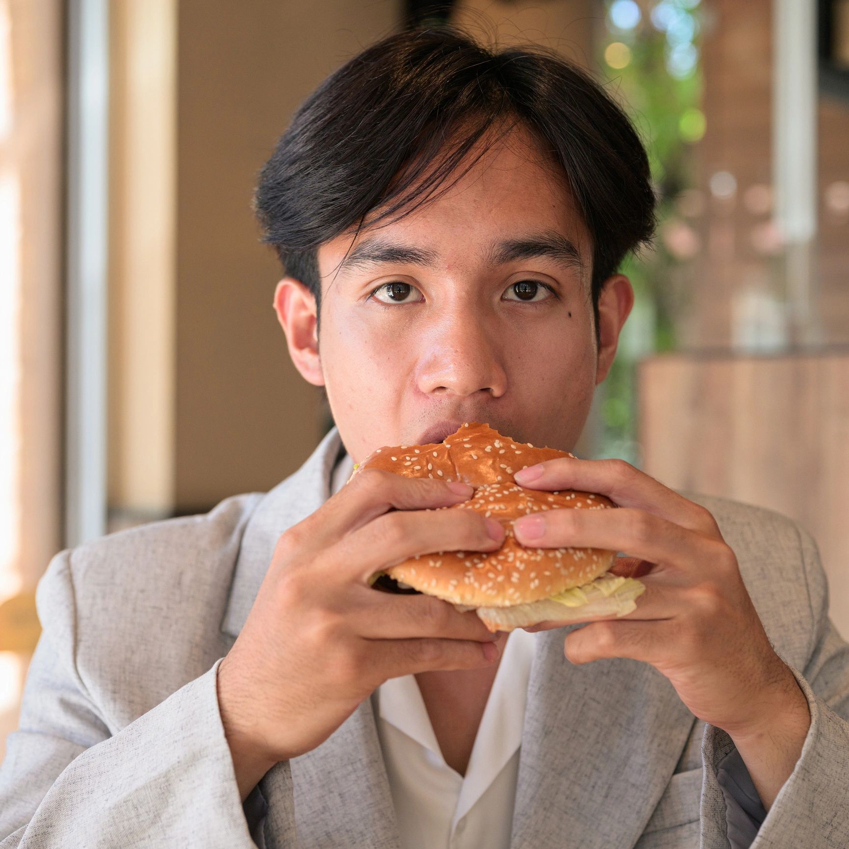 Happy restaurant guest enjoying a burger