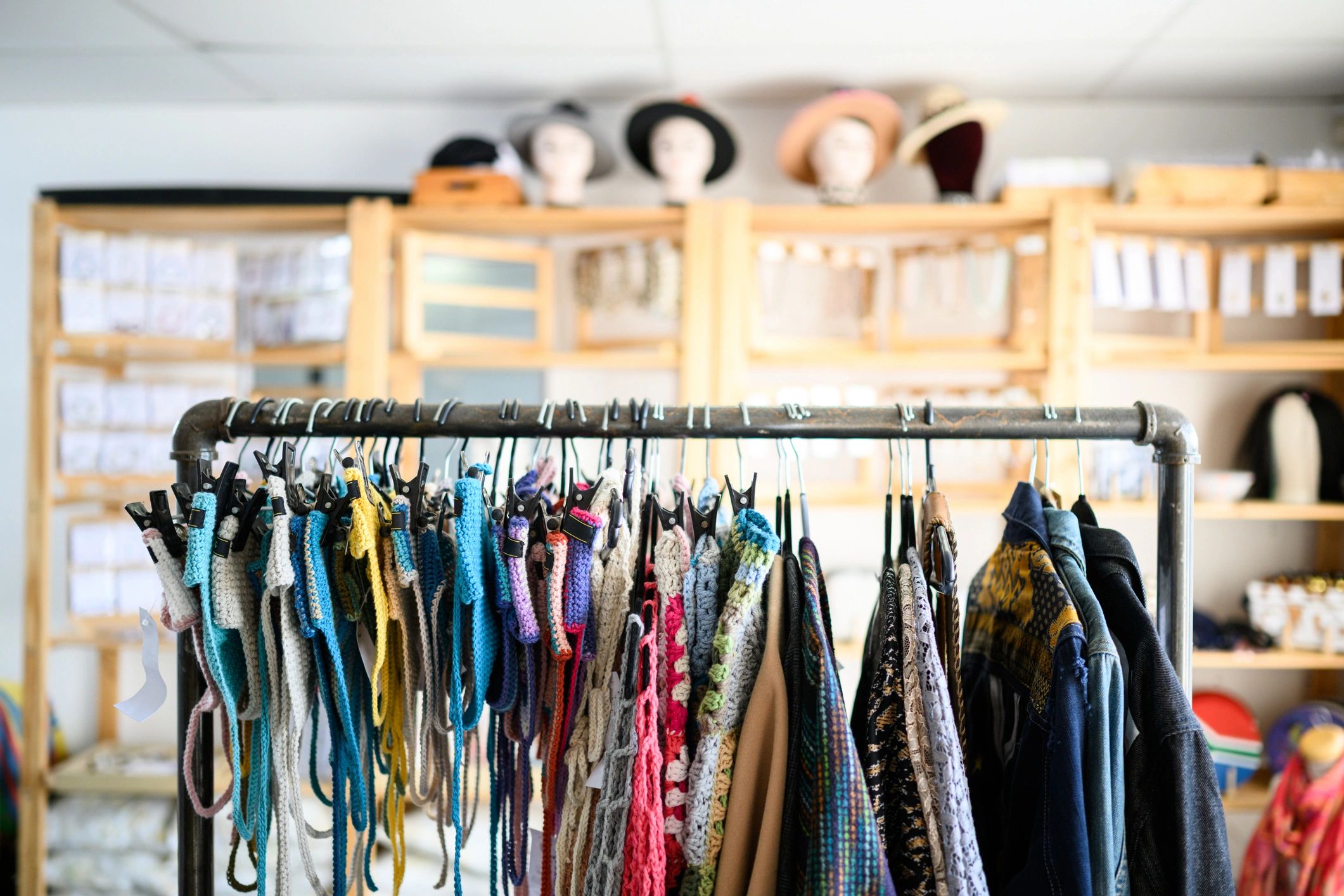 Wide shot of fashion display rack with colourful clothing in local boutique